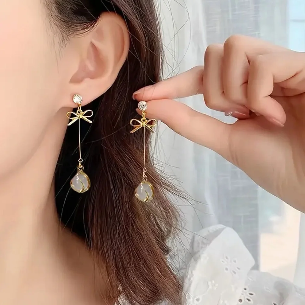 Elegant Gold and White Drop Earrings. Christmas ball and bow earrings.